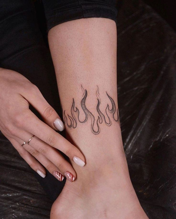 a woman's foot with tattoos on it