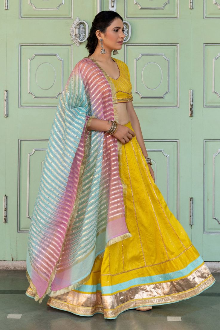 Yellow chanderi blend lehenga with gota, sequin work panel details and border. Paired with embroidered back tie-up blouse and ombre gota work stripes dupatta with fringe lace border.
Component: 3
Pattern: Embroidered
Type Of Work: Gota and Sequin Work
Neckline: V Neck
Sleeve Type: Half Sleeves
Fabric: Chanderi Blend
Color: Yellow
Other Details: 
Back tie-up belt, hook and eye closure on blouse
Occasion: Sangeet,Haldi and Mehendi - Aza Fashions V Neck Lehenga, Gota Work, Belt Hook, Embroidered Lehenga, Lace Border, Set For Women, Aza Fashion, Sleeve Type, Half Sleeves