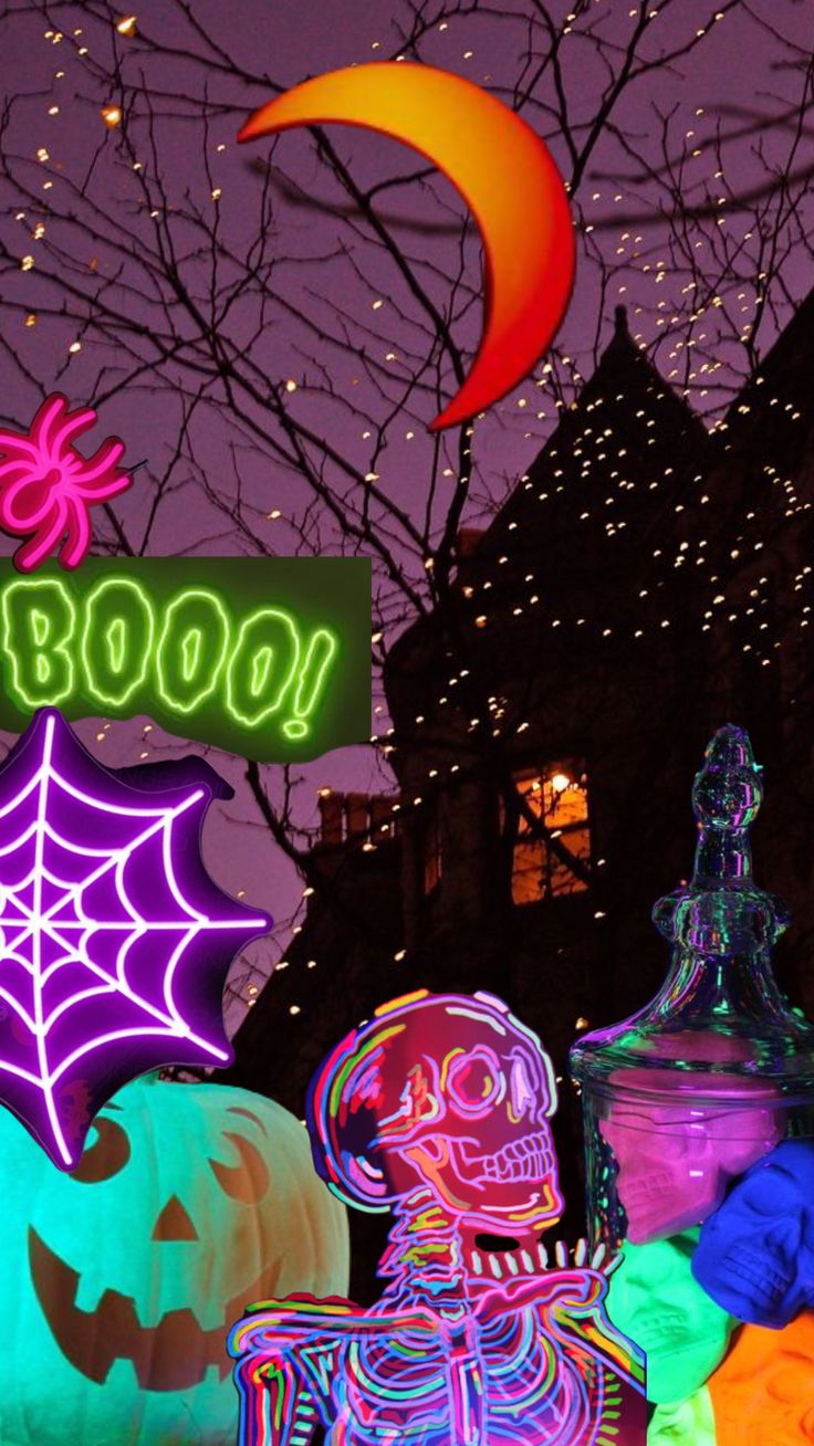 halloween decorations are lit up at night in front of a building with a sign that says boooo