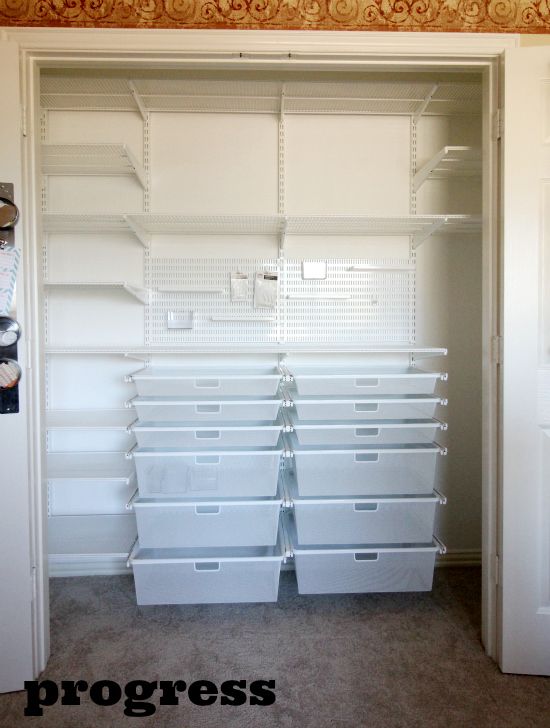 the closet is full of white plastic bins