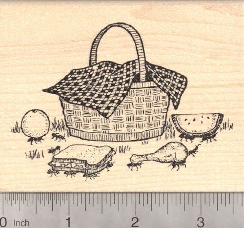 a rubber stamp with a picnic basket and other food items on it, next to a ruler