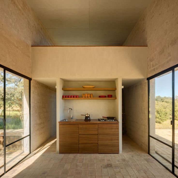 an open kitchen and dining area with sliding glass doors