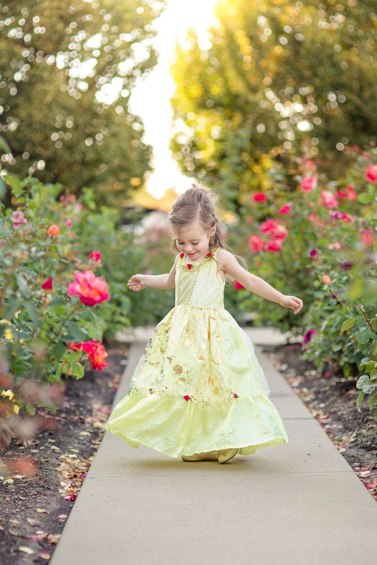 Get your little one ready to dance the night away in a giant castle as they enter into their own fairy tale with this classically designed ballgown. Yellow stretch velvet bodice with gold crosshatch inset Accented with red roses on the neck line and overskirt Yellow china silk skirt with an organza overskirt that has a golden rose pattern print Breathable, Silky Soft, 100% Polyester Fabrics Accessories Sold Separately Sleeveless Embroidered Princess Dress For Dress-up, Yellow Princess Dress Fairytale, Yellow Elegant Dress Kids, Disney Princess Dresses For Kids Belle, Yellow Princess Dress Kids, Golden Rose, Beauty Dress, Fabric Accessories, Stretch Velvet