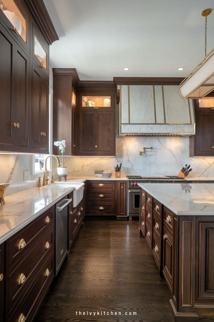 a large kitchen with wooden cabinets and marble counter tops, along with dark wood flooring