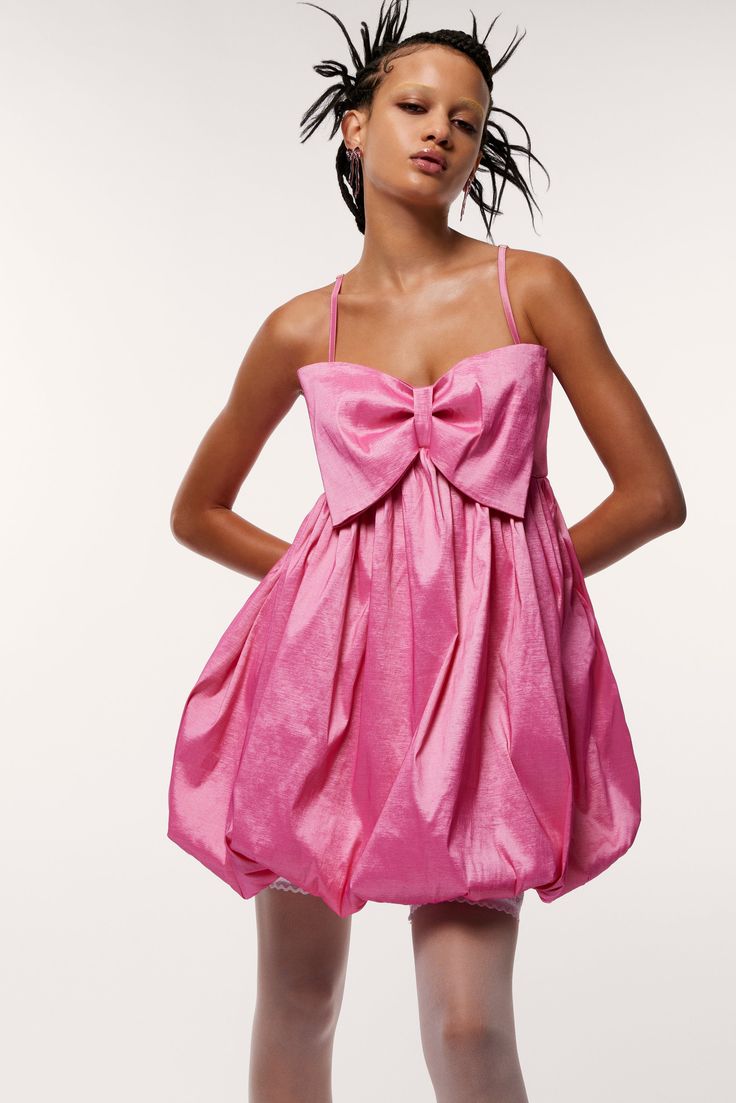 Look cute as a bow in our charming MEGAN BOW DRESS! This baby doll mini dress has a bubbly hem, spaghetti straps, and a supersized bow for a giggle-inducing and flirtatious vibe. Ideal for a night out or a special event. 100% Polyester Shell: 66% Polyester, 30% Nylon,4% Spandex Upper Lining: 66% Polyester, 30% Nylon, 4% Spandex Lower Lining: 100% Polyester (Exclusive of Elastic) Care instructions: Dry clean or hand wash cold. Do not bleach. Lay flat to dry Model is 5ft 10in and is wearing a size small Measurements (inches): SIZE BUST WAIST HIP S 25" 36" 46" M 27" 37" 47" L 29" 38" 48" Imported Spring Mini Dress With Detachable Bow, Summer Sleeveless Mini Dress With Detachable Bow, Sleeveless Summer Mini Dress With Detachable Bow, Pink Bow Mini Dress For Party, Pink Party Mini Dress With Bow, Pink Feminine Mini Dress With Bow Tie Back, Feminine Pink Mini Dress With Bow Tie Back, Pink Party Dress With Detachable Bow, Flirty Pink Mini Dress With Bow