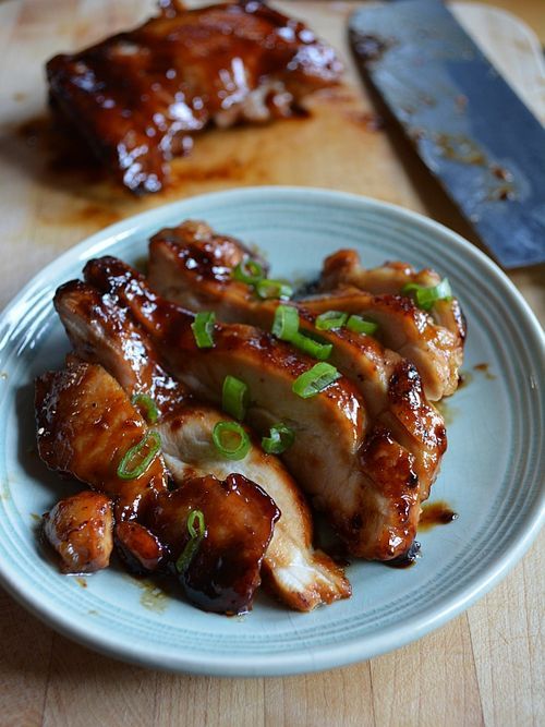 chicken wings with sauce and green onions on a plate