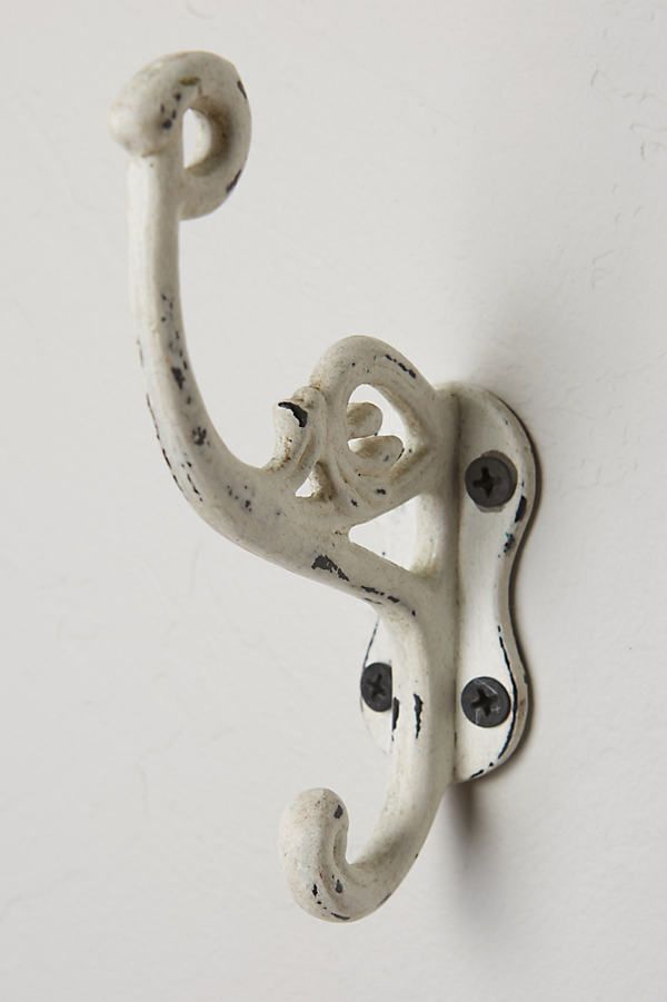 an old white door handle on a white wall