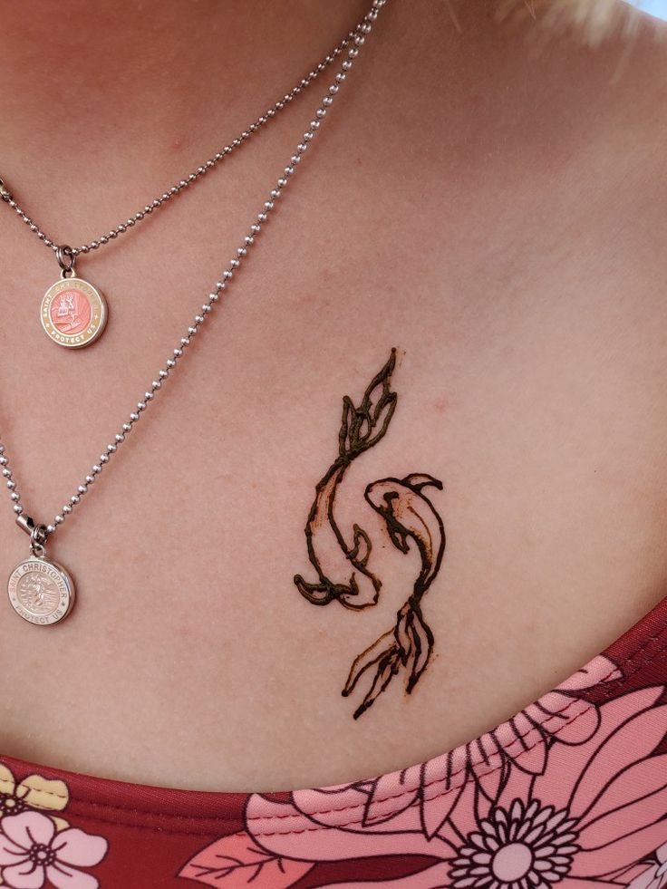 a close up of a woman's chest with tattoos on it