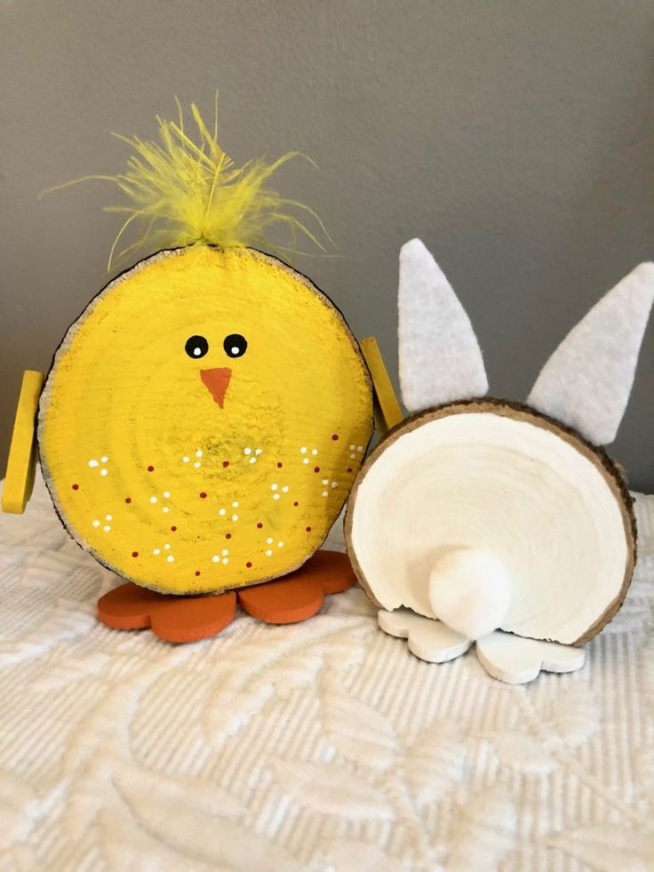 a small yellow chicken next to a coconut shell