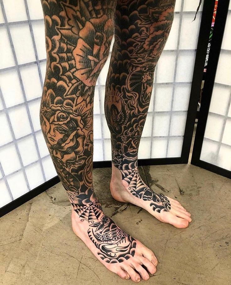 a man with tattoos on his legs and feet