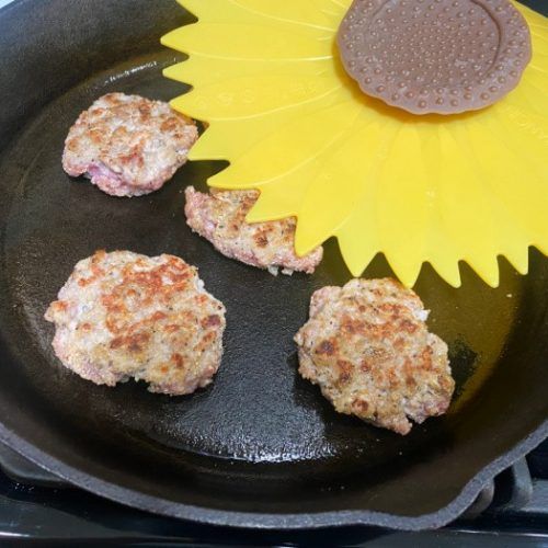 some food is being cooked in a pan with a flower on the side and sunflower