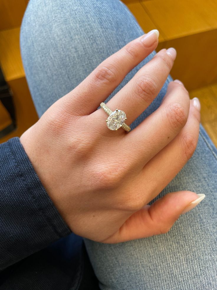 a woman's hand with a diamond ring on it