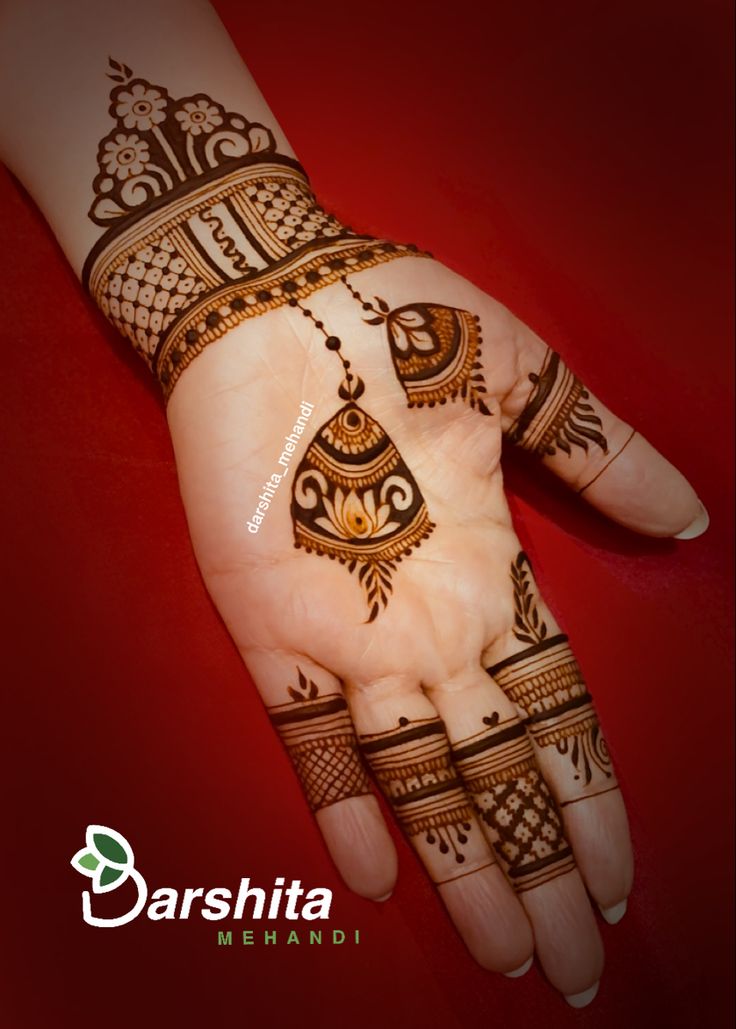 the hand is decorated with henna designs