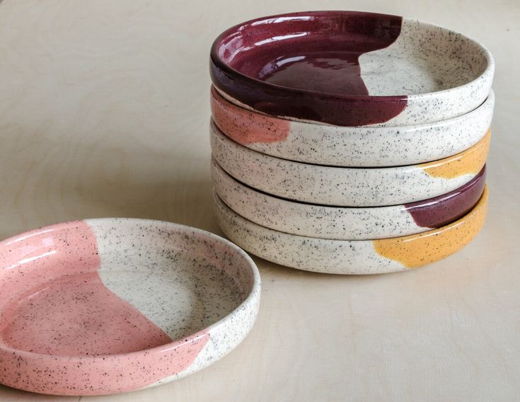 four bowls are stacked on top of each other