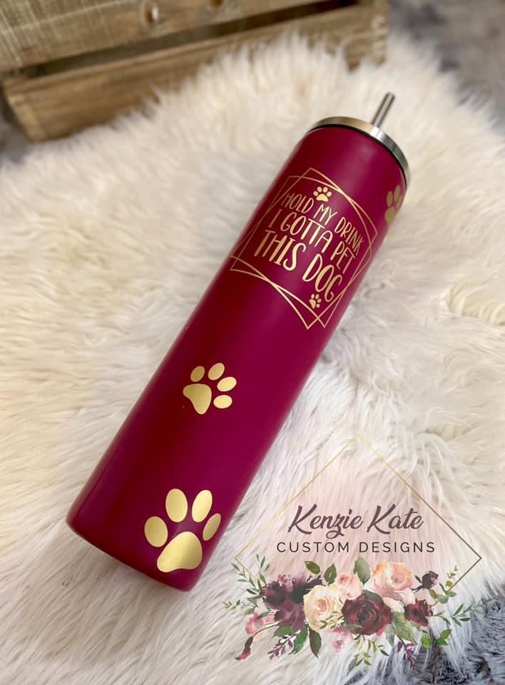 a red can with gold paw prints on it sitting on a white fur covered floor