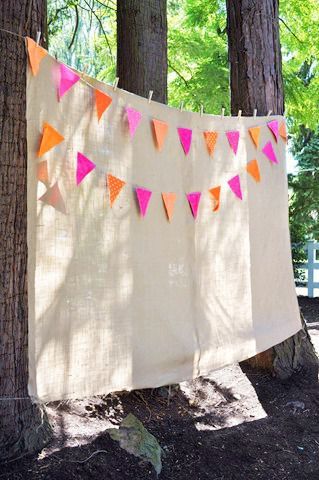 an orange and pink bunting is hanging in the woods