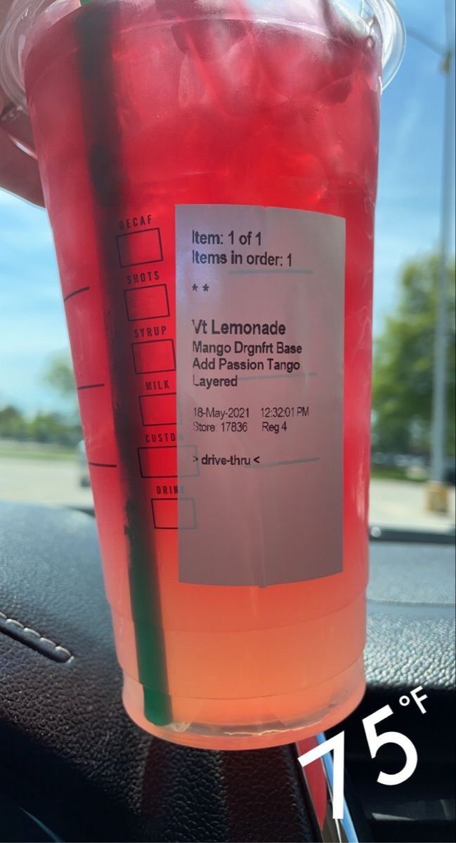 a cup with liquid in it sitting on top of a table next to a meter