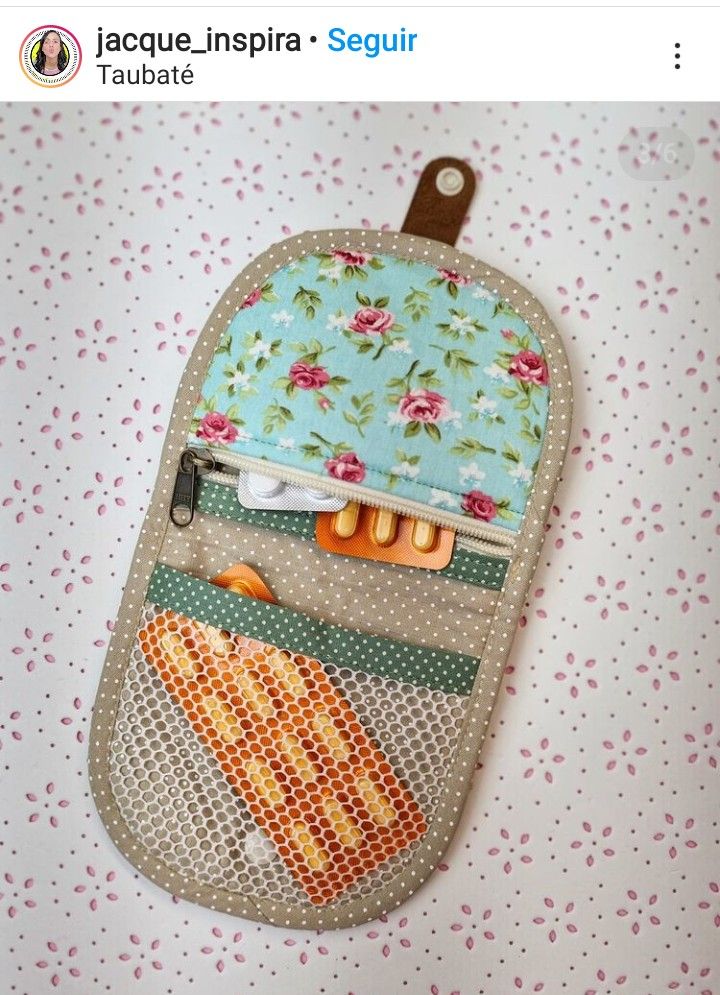 an oven mitt is hanging on a table with flowers and polka dot fabric in the background