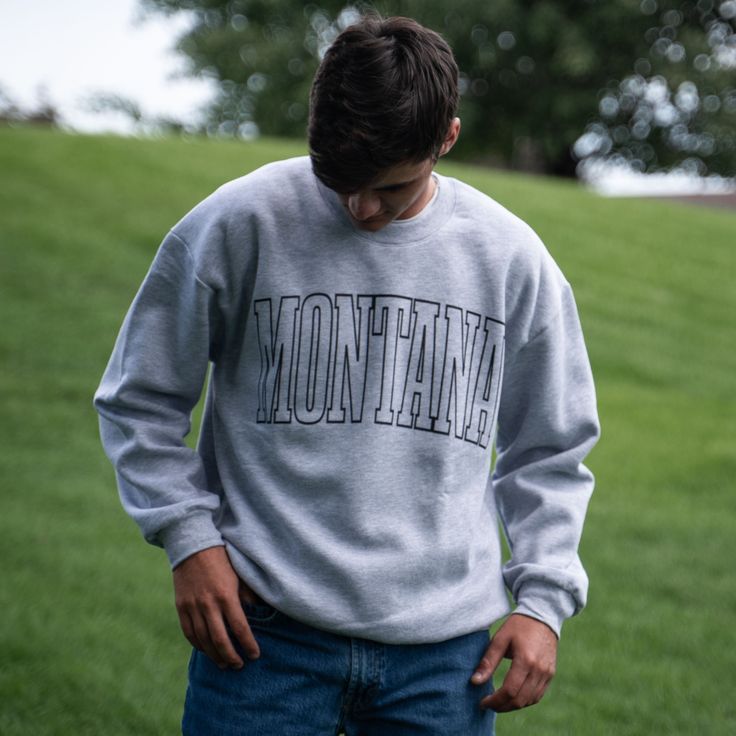 Represent your state pride in style with our Montana Unisex Pullover! Featuring bold, large lettering, this heather grey pullover is the perfect addition to your wardrobe. Show off your love for Montana in a fun and fashionable way. 70/30 Cotton/PolyesterRelaxed FitChest Width: S-20", M-22", L-24", XL-26, 2X-28"Body Length: S-28", M-29", L-30", XL-31" 2X-32" A Montana Scene Original Design. Printed in Montana. All designs are property of The Montana Scene. All rights reserved. Come visit our sto Kids Onesies, Kids Beanies, Sticker Patches, Grey Pullover, Sock Gifts, Kids Hats, Kid Tees, Store Fronts, All Design