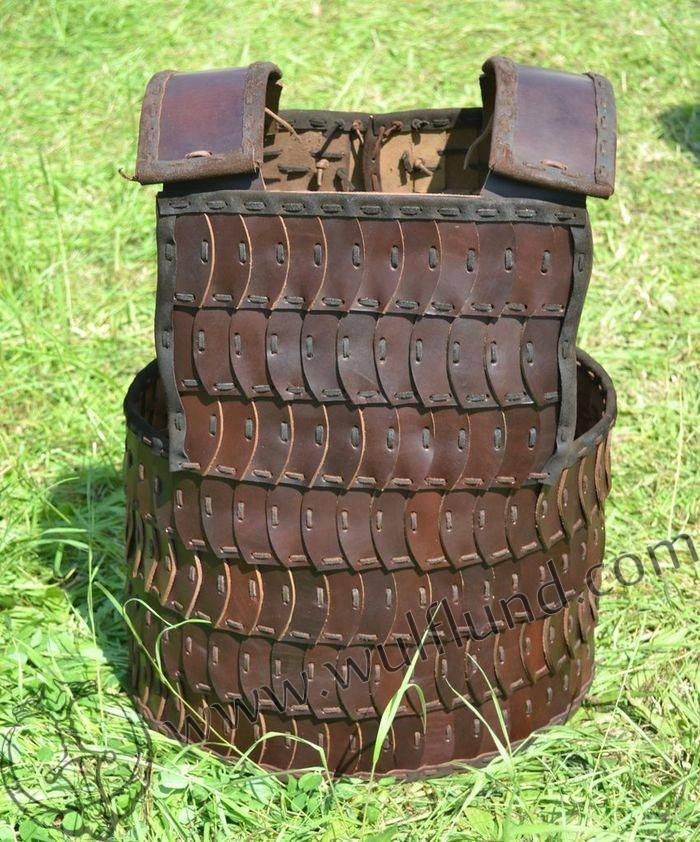 a large brown basket sitting on top of a lush green field