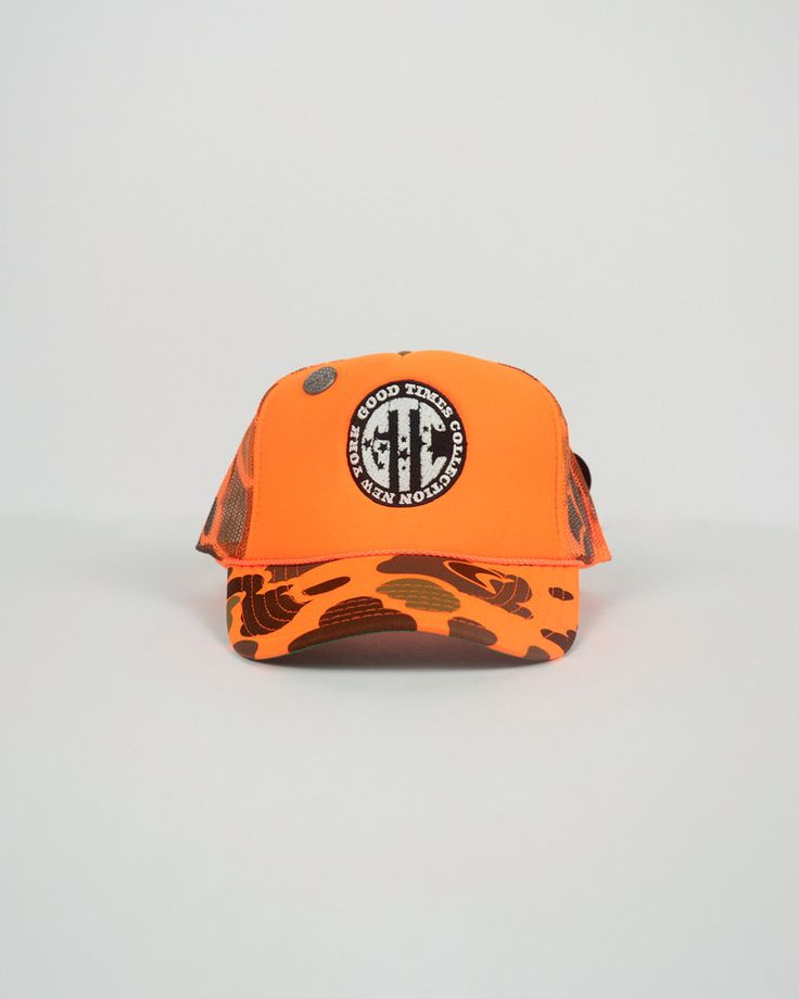 Step up your street style with our exclusive orange camo hat embroidered with a bold black and white logo. Crafted with utmost precision and attention to detail, this exquisite headwear effortlessly combines fashion-forward design with unparalleled comfort. This head turning accessory screams luxury and unique style. The distinctive pins also aides in the trucker’s exceptional rare look. Orange Trucker Hat For Streetwear, Orange Trucker Hat For Sports, Orange Snapback Hat With Curved Brim For Outdoor, Outdoor Orange Snapback Hat With Curved Brim, Orange Snapback Hat For Outdoor, Orange Sports Cap, Orange Curved Brim Snapback Hat For Outdoor, Orange Snapback Hat For Sports, Outdoor Orange Snapback Hat