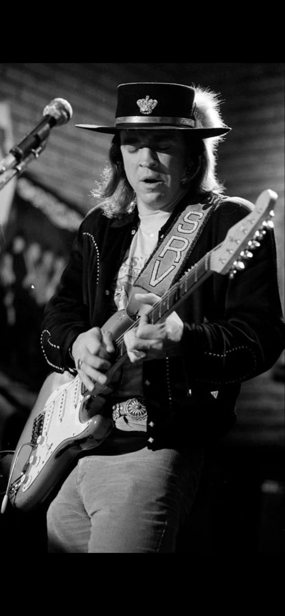 black and white photograph of a man playing an electric guitar