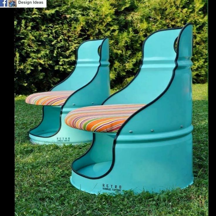 two blue plastic chairs sitting in the grass