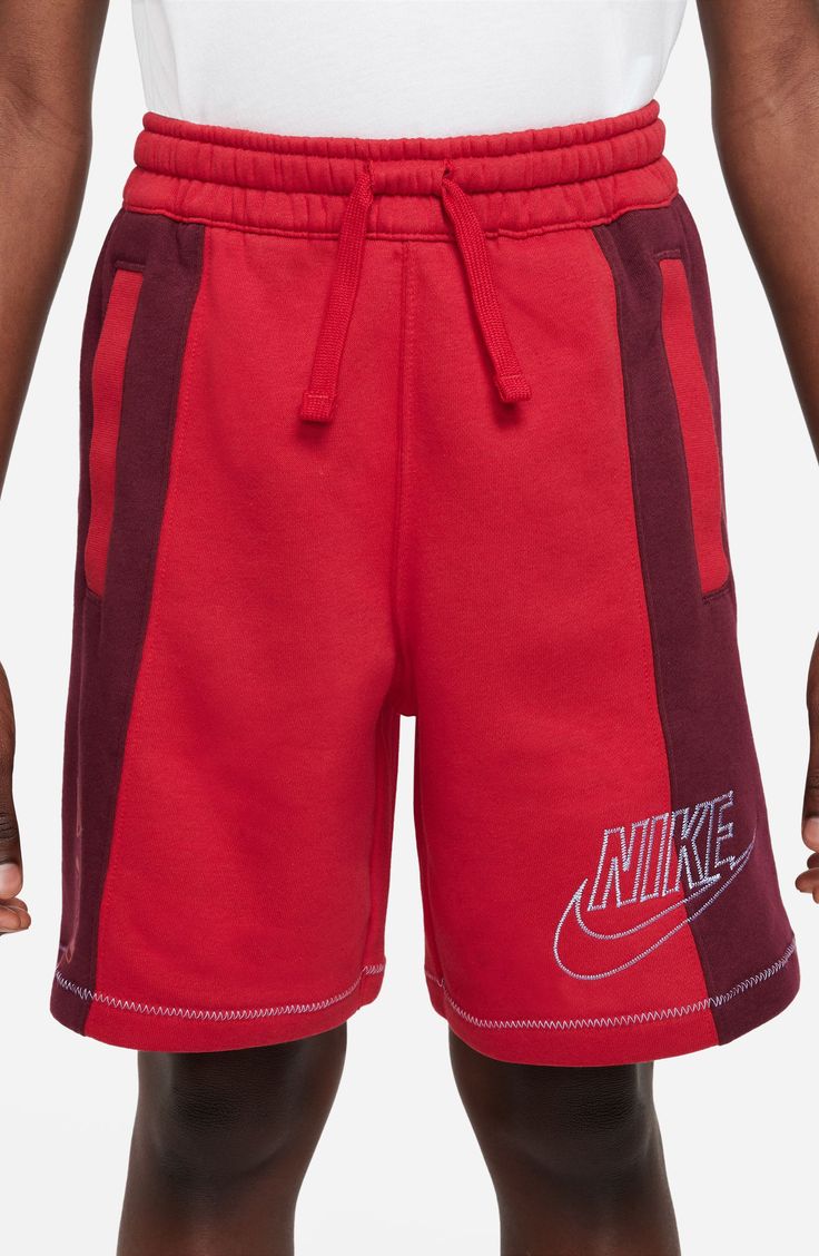 Comfort and style balance out in these kid-approved cotton-blend shorts fashioned with a drawstring waist and stand-out logo stitching. 80% cotton, 20% polyester Machine wash, tumble dry Imported Red Cotton Athletic Shorts For Sports, Cotton Sportswear Shorts For Sports, Sporty Red Cotton Athletic Shorts, Sporty Red Cotton Activewear, Red Cotton Sporty Athletic Shorts, Red Cotton Athleisure Activewear, Nike Red Sporty Shorts, Sporty Red Shorts For Playwear, Sporty Drawstring Shorts For Playwear