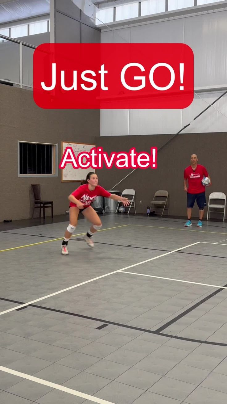 two women are playing tennis in an indoor court with the words just go activate above them