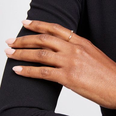 a close up of a person's hand wearing a ring