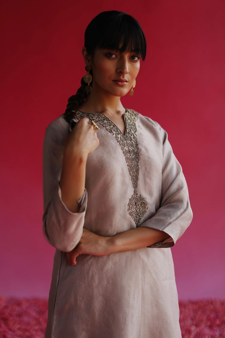 Grey straight fit kurta, highlighted with floral zari embroidery on the placket.
Components: 1
Pattern: Placement Embroidery
Type Of Work: Zari, Floral
Neckline: Notched V Neck
Sleeve Type: Three Quarter Sleeves
Fabric: Pure Zari Tissue Silk 
Color: Grey
Other Details: 
Note: Pant worn by the model is not for sale
Occasion: Puja,Mehendi and Haldi - Aza Fashions Placement Embroidery, Kurta For Women, Zari Embroidery, A Line Kurta, Beaded Neckline, Silk Embroidery, Fashion App, Pant Set, Three Quarter Sleeves