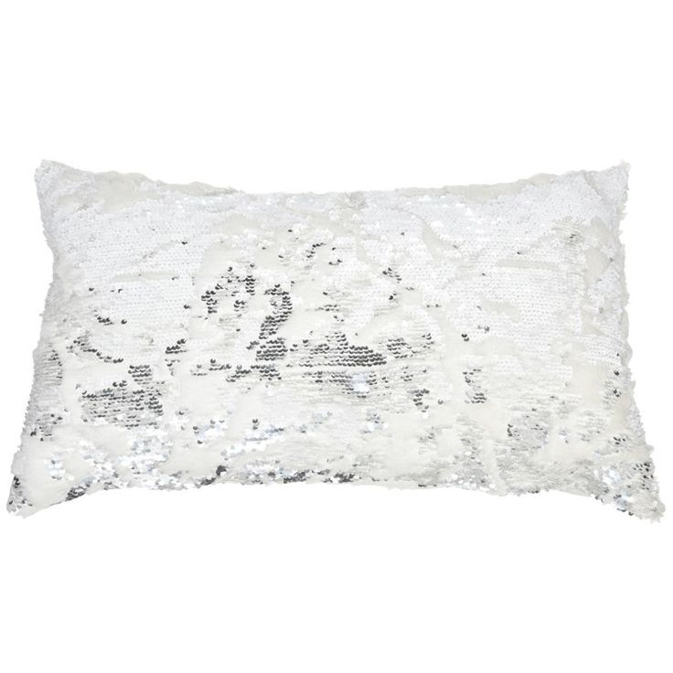 a white pillow with silver sequins on the front and back, against a white background