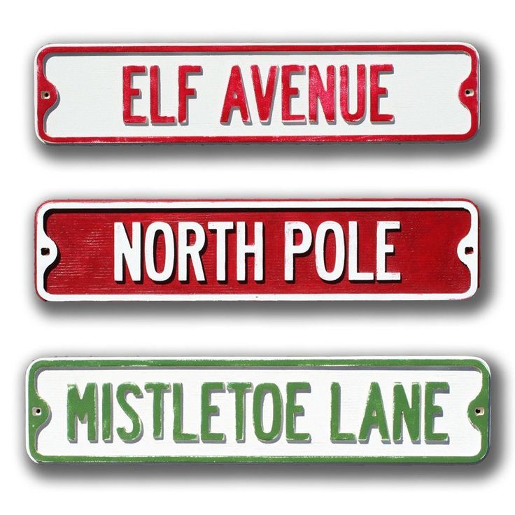 three red and white street signs with the words north pole, mistletoe lane, elf avenue and north pole