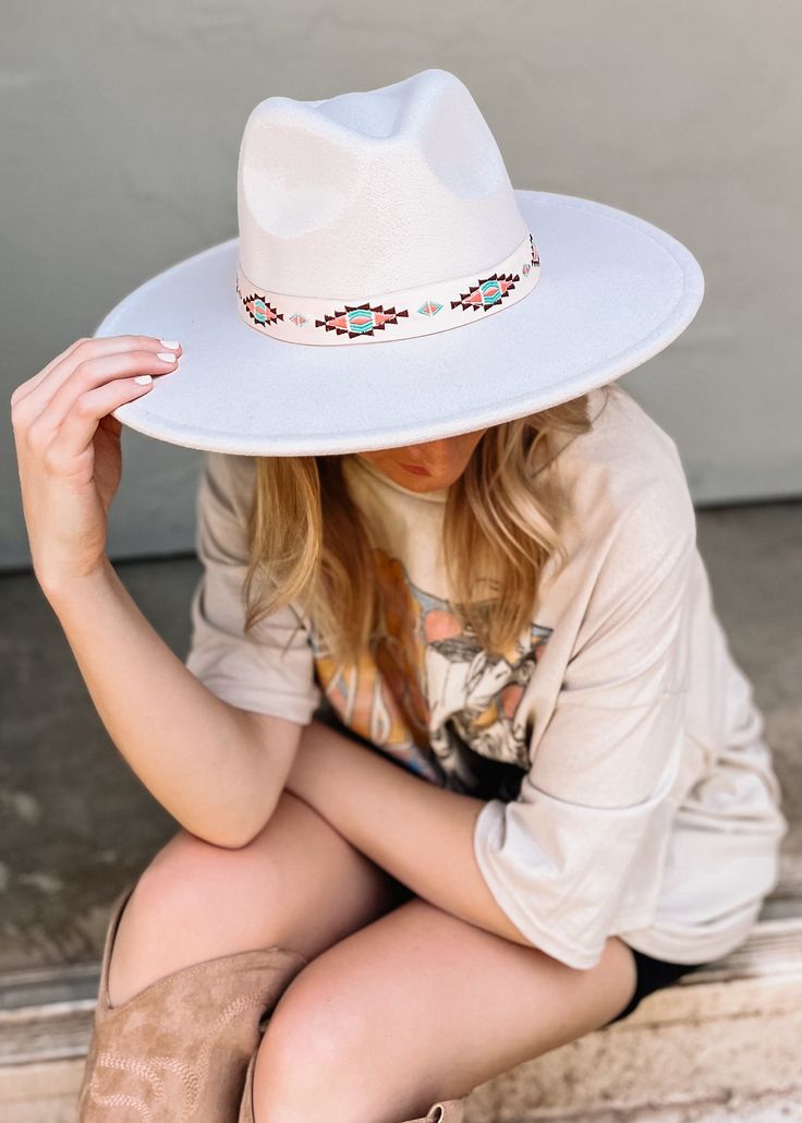 Finish off your already fall chic look with this felt hat featuring a boho embroidered band. Imported 100% Polyester Color: Off White White Bohemian Wide Brim Hat, White Southwestern Short Brim Hat, White Bohemian Hat, White Bohemian Felt Hat For Rodeo, White Adjustable Felt Hat For Festival, Adjustable White Felt Hat For Festivals, Adjustable White Felt Festival Hat, White Flat Brim Hat For Festivals, Festival Felt Fedora Hat