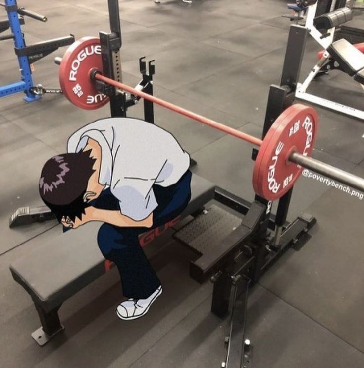 a man squatting down on a bench in a gym with barbells behind him