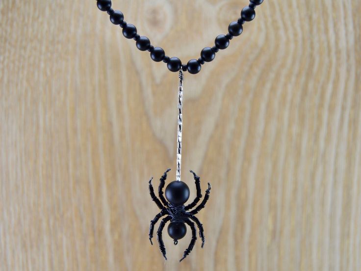 Perfect for Halloween! This haunting necklace is a one of a kind piece handmade in Chicago IL. This necklace was made of onyx beads strung on a 16 in sterling silver cord. The onyx spider was wrapped in sterling silver and hangs on a 1.75 in web. The spider is 1.5 in tall and 1 in wide. Thank you for checking out my shop! Please feel free to message with any questions or requests. Happy Halloween! Unique Black Halloween Necklace, Black Sterling Silver Necklace For Halloween, Bead Spider, Tangerine Quartz, Spider Necklace, Fröhliches Halloween, Beaded Spiders, Cluster Necklace, The Spider