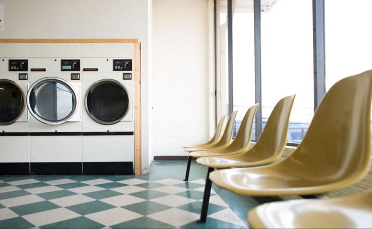 a row of chairs sitting in front of washers