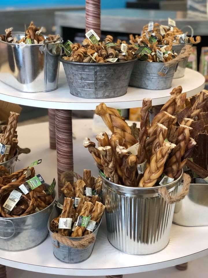 several buckets filled with food sitting on top of a white table next to each other