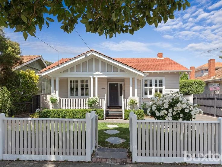 a white picket fence in front of a house