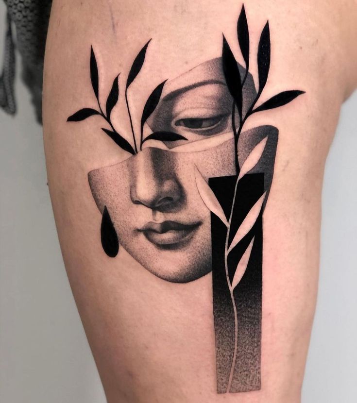 a woman's thigh with an abstract face and leaves on the side, in black and white