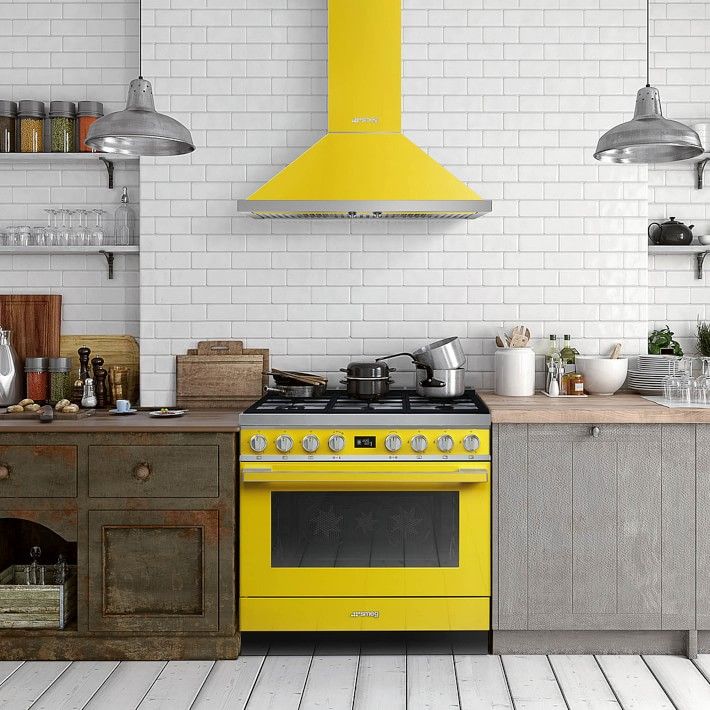 a yellow stove top oven sitting inside of a kitchen