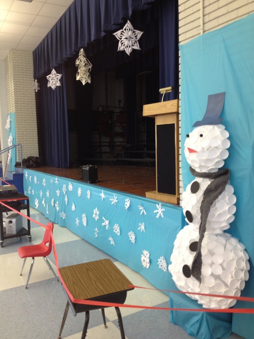 a snowman made out of paper on the side of a stage