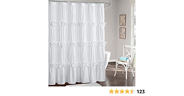 a white shower curtain with ruffles on the top and bottom, in front of a