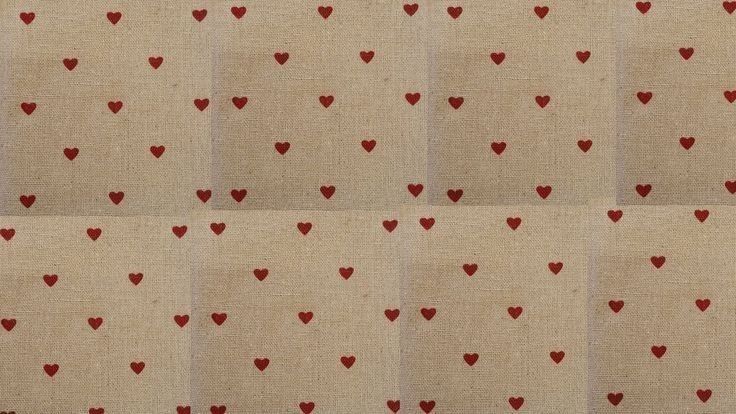 red hearts are arranged on beige fabric