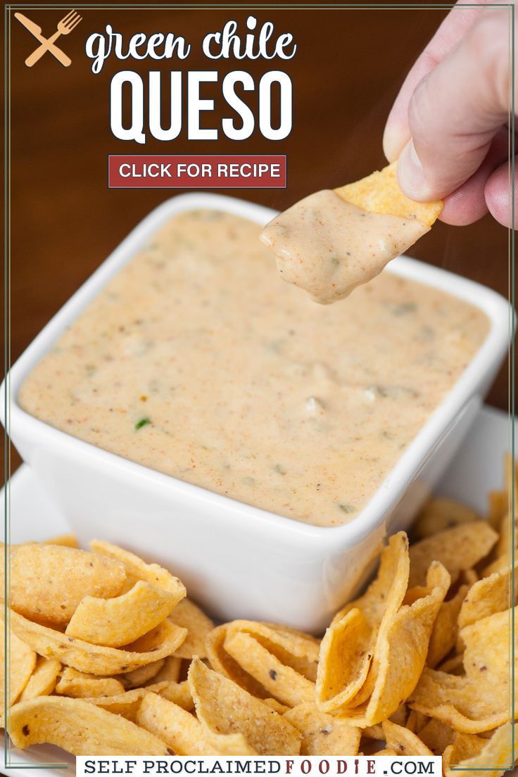 a person dipping tortilla chips into a white bowl