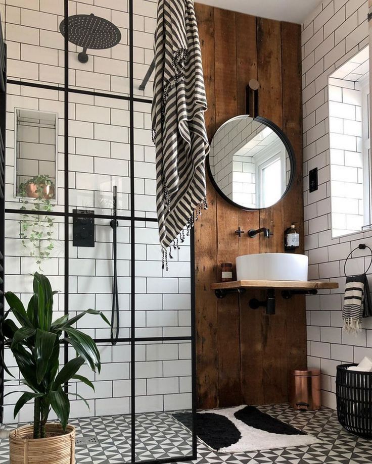 the bathroom is decorated in black and white tile