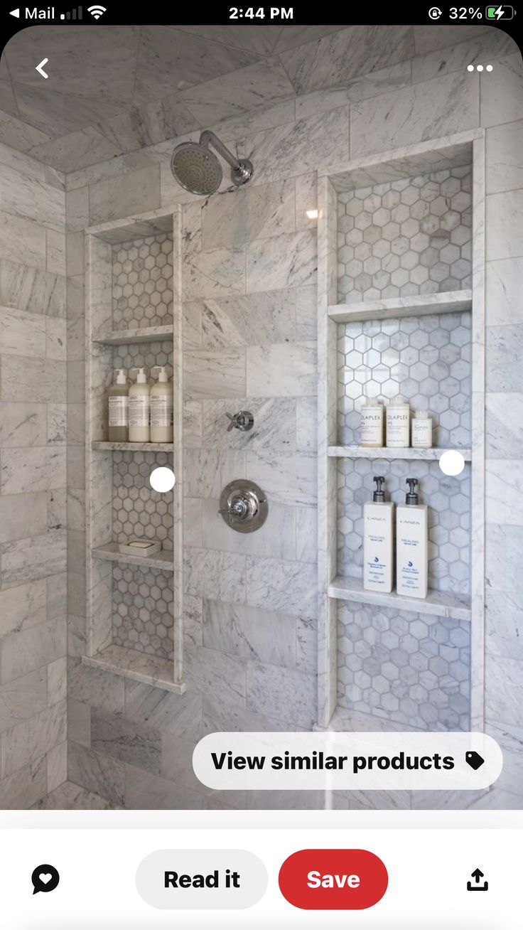 a bathroom with marble walls and shelving in the shower