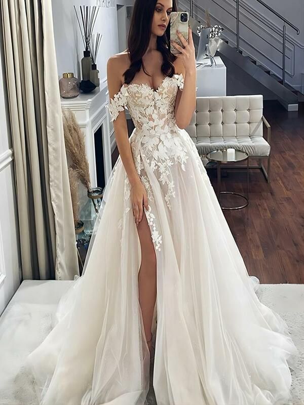 a woman is taking a selfie in her wedding dress while standing on the floor