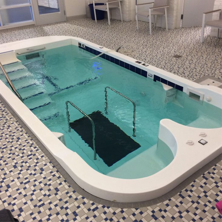 an indoor swimming pool with steps leading up to it