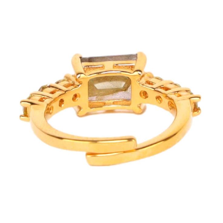 Channel your inner Princess! The center of this masterpiece is a beautiful emerald cut stone on an adjustable gold wrap band. On the band are 3 small, brilliant cut stones. The richness of colors forms a connection between power and wealth. Join the ranks of royalty with our charming Princess ring a must-have statement piece. Wonderful when stacked on your finger with your favorite gold or silver rings. Handcrafted in India. Sizable. Available in Amethyst, Clear Crystal, and Smokey Crystal. Mind Gold Jewelry With Square Cut Accent Stones, Square Cut Gold Jewelry With Accent Stones, Gold Crystal Ring With Rectangular Stone For Wedding, Gold Rings With Rectangular Gemstone, Gold Jewelry With Rectangular Accent Stones, Luxury Gold Emerald Ring With Three Stones, Gold Open Ring With Gemstone Accents, Adjustable Gold Ring With Gemstone Accents, Gold Rectangular Rings With Accent Stones